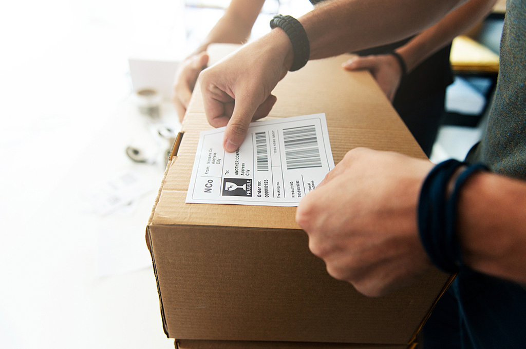 Logistics barcode and shipping labels applied to packaging boxes — industrial label printing application